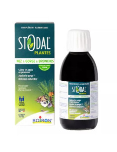 flacon brun opaque boite verte foncé avec des plantes dessus